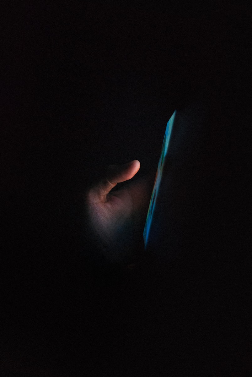 Photo by Akshar Dave🌻 person holding blue light in dark room